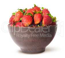 Ripe juicy strawberries in a ceramic bowl