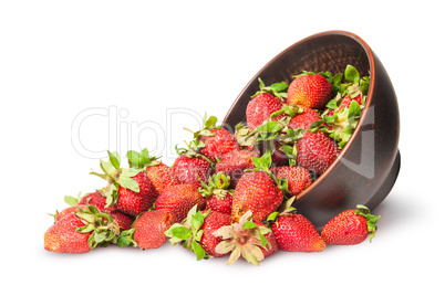 Scattered ripe juicy strawberries in a ceramic bowl