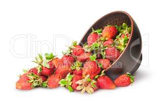 Scattered ripe juicy strawberries in a ceramic bowl