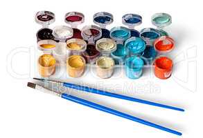 Set of colorful acrylic paints in jars and two brushes