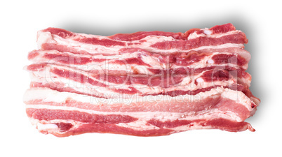 Several pieces of bacon stacked in layers