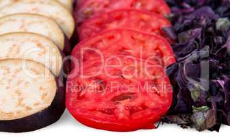 Sliced eggplant tomato and basil leaves