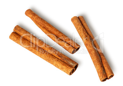 Three cinnamon sticks lie nearby