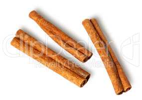 Three cinnamon sticks lie nearby