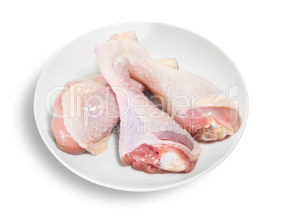 Three Raw Chicken Legs On White Plate