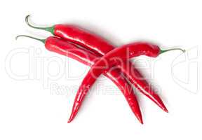 Three red chili peppers crisscross