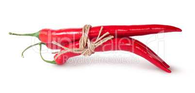 Three red chili peppers tied with a rope reversed