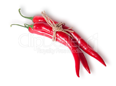 Three red chili peppers tied with a rope top view
