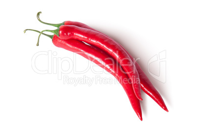 Three red ripe juicy hot chili peppers top view