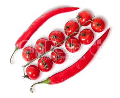 Two chili pepper and cherry tomatoes on stem top view