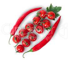 Two chili pepper and cherry tomatoes on stem with parsley