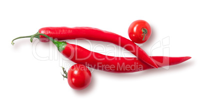 Two chili pepper and two cherry tomatoes top view