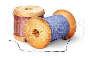 Two different colored thread on wooden spools