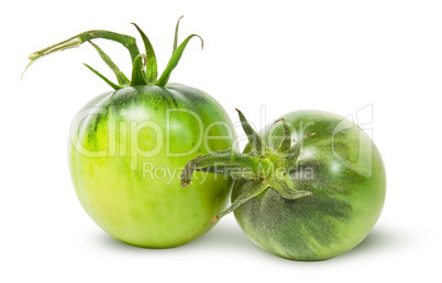 Two green tomatoes near