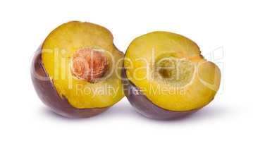 Two halves of violet plums near