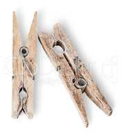 Two old wooden clothespins beside