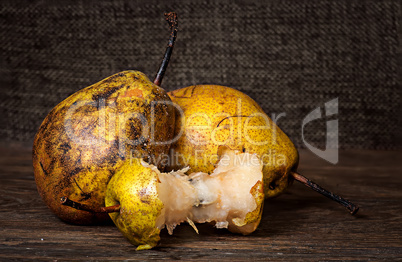 Two pears and stub on wooden table