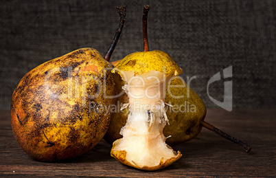 Two pears and stub standing on wooden table