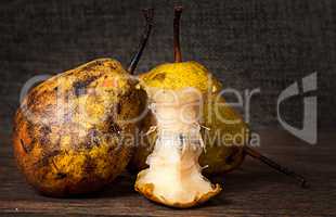 Two pears and stub standing on wooden table