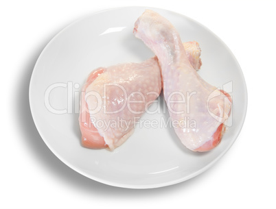 Two Raw Chicken Legs On White Plate