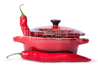 Two red chili peppers and saucepan with lid