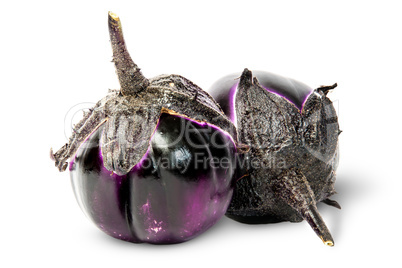 Two round eggplants mature lying near