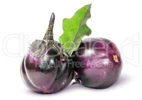 Two round ripe eggplant with green leaf