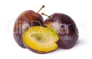 Two violet plums and half