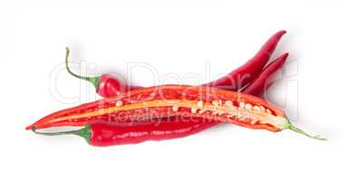 Two whole and one half red chili peppers