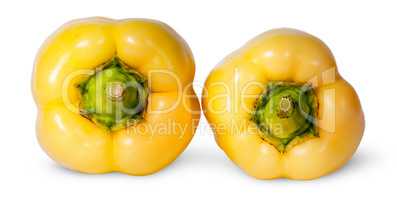 Two yellow bell peppers lying beside
