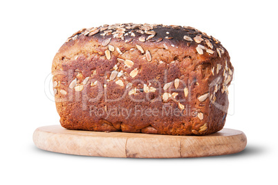 Unleavened bread with seeds and dried fruit on wooden board