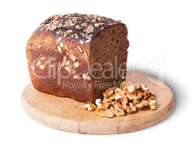 Unleavened bread with seeds on wooden board with nuts