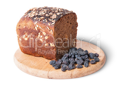 Unleavened bread with seeds on wooden board with raisins