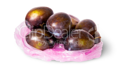 Whole violet plums in plastic bag