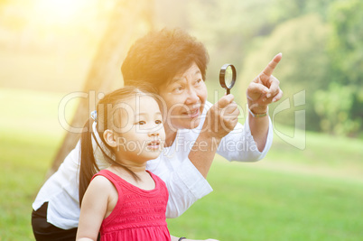 Grandmother and granddaughter exploring outdoor.