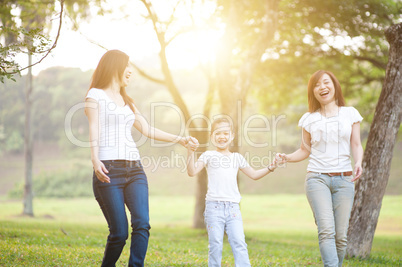 Asian family playing outdoors