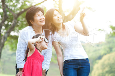 Grandmother, mother and daughter exploring outdoor.
