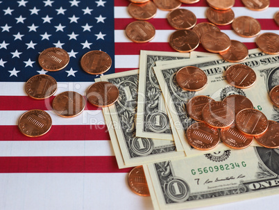 Dollar notes and coins and flag of the United States