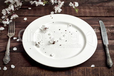 Porcelain plate with a wilkyo and knife on a brown table