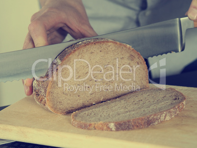 Man is cutting bread