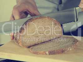 Man is cutting bread