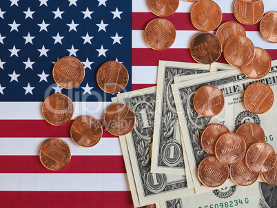 Dollar notes and coins and flag of the United States