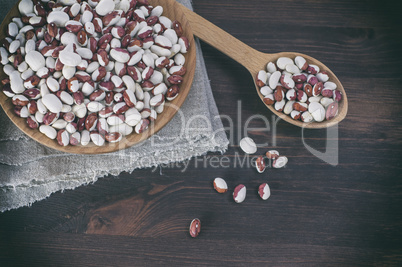 Red white beans in a wooden bowl and spoon