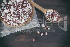 Red white beans in a wooden bowl and spoon