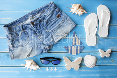 Summer Clothes And Decoration On Wooden Background