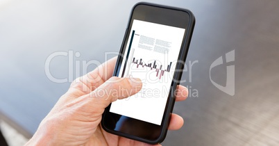 Businessman analyzing graphs on smart phone