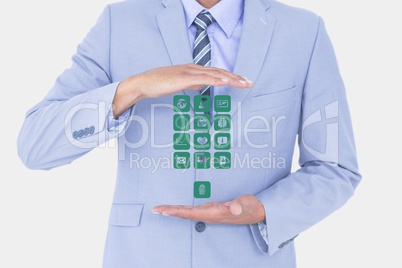 Digitally generated image of businessman holding various icons against white background