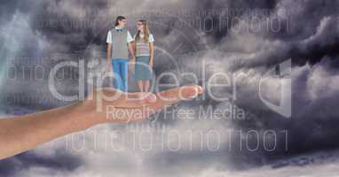 Digitally generated image of man and woman standing on hand against sky