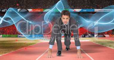 Digital composite image of businessman at starting line with wave pattern in background