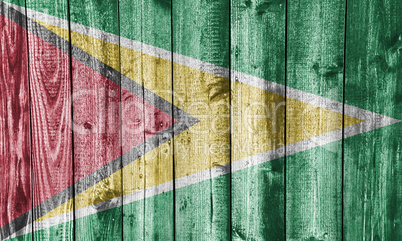 Fahne von Guyana auf verwittertem Holz